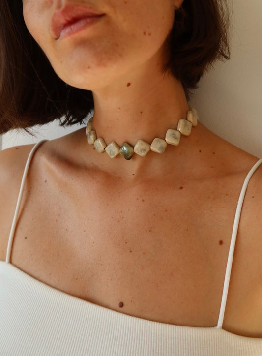 Monti handmade ceramic choker necklace in Sparkling White and Light Green, worn on soft skin — sculptural beads inspired by Roman architecture, made in Lisbon Portugal by Jadeo Studio