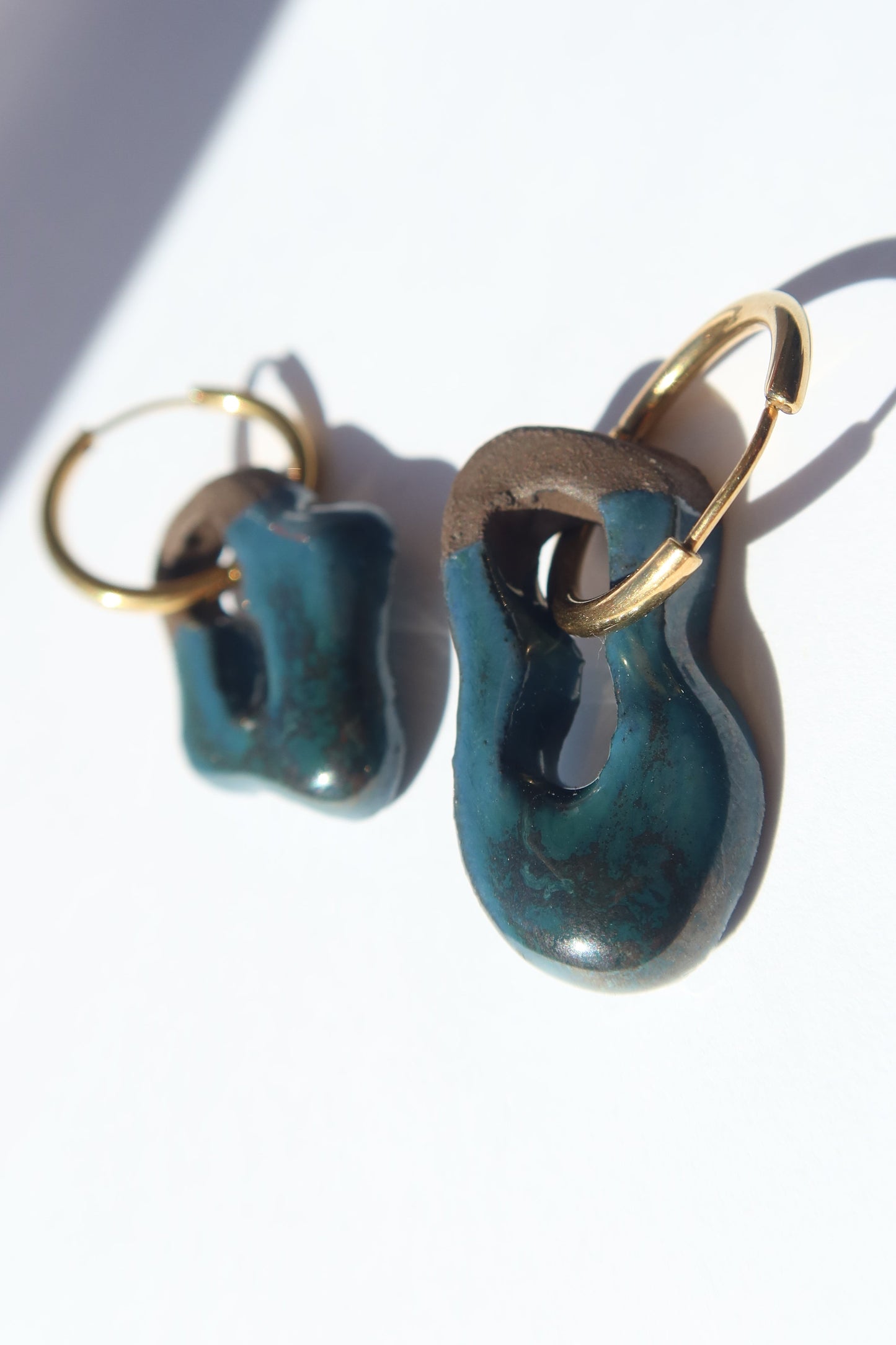 Mosca handmade ceramic earrings in Blue Green on Dark Clay — organic sculpted clay with glossy glaze, made in Lisbon Portugal by Jadeo Studio, Lisbon lifestyle