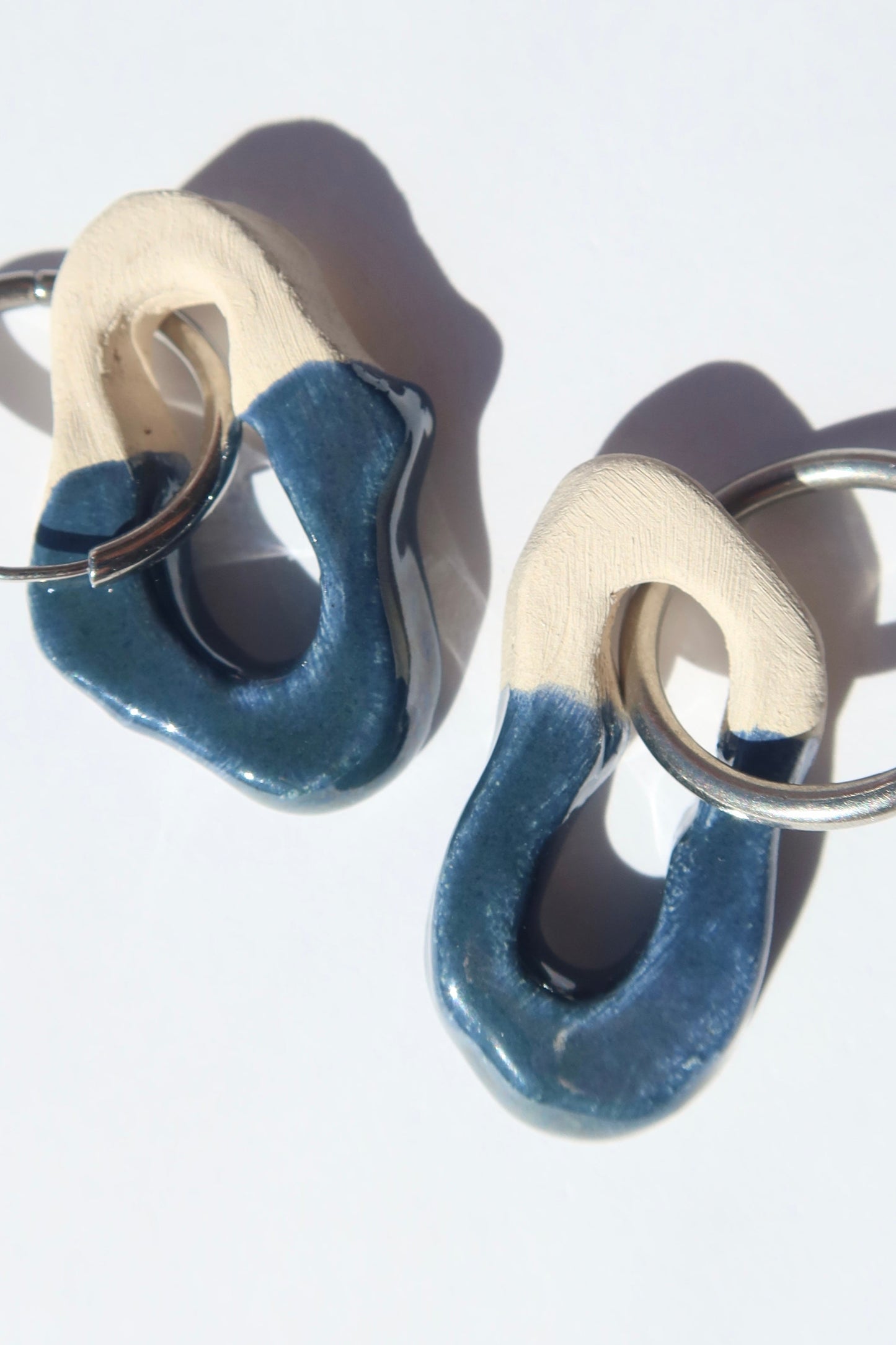 Mosca handmade ceramic earrings in Blue Green — organic sculpted clay with glossy glaze, made in Lisbon Portugal by Jadeo Studio, silver and gold hoop