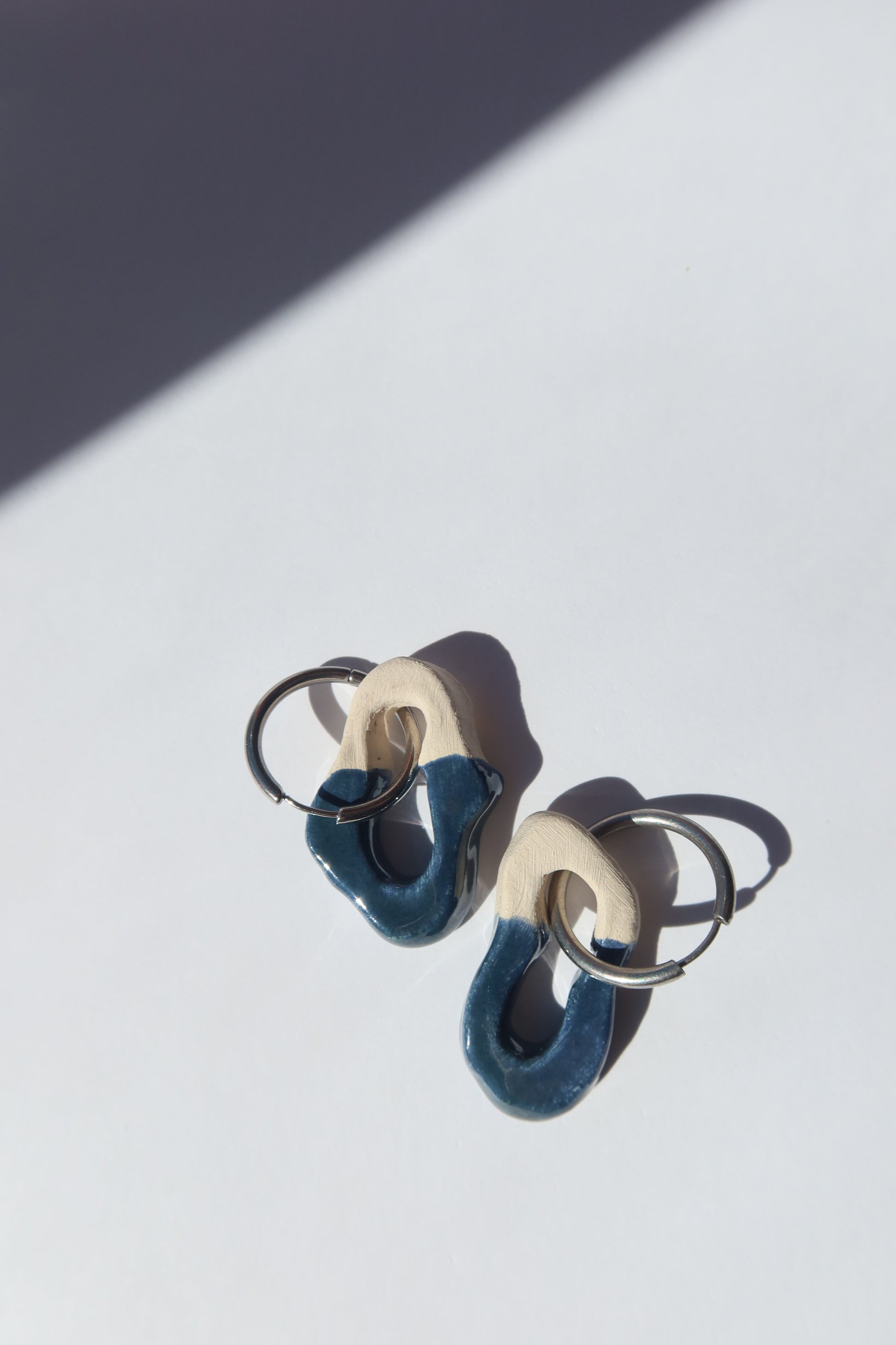 Mosca handmade ceramic earrings in Blue Green — organic sculpted clay with glossy glaze, made in Lisbon Portugal by Jadeo Studio, Lisbon lifestyl