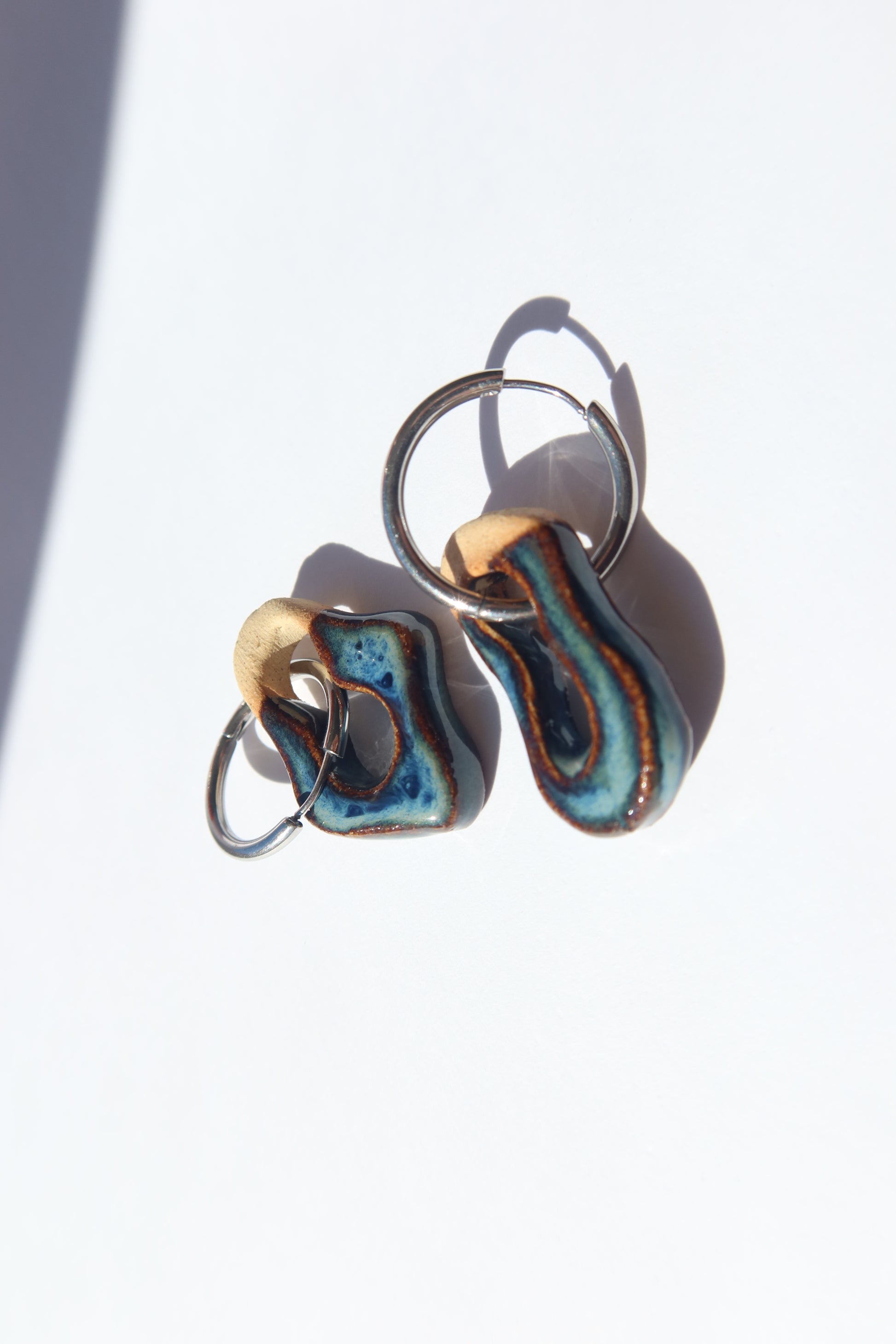 Mosca handmade ceramic earrings in Blue Jeans — organic sculpted clay with glossy glaze, made in Lisbon Portugal by Jadeo Studio, ilver and gold hoop