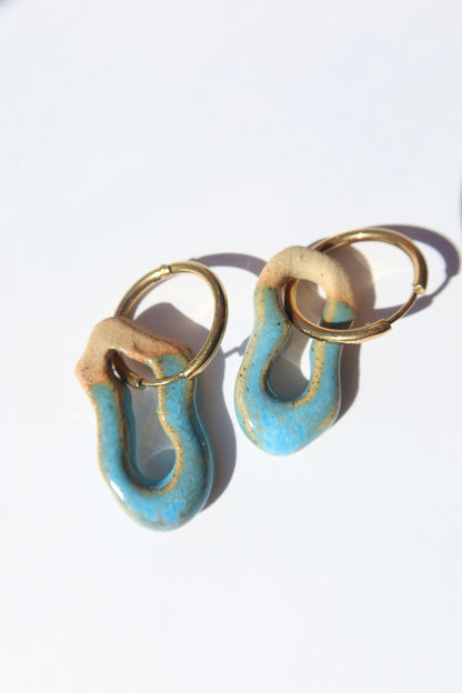 Mosca blue sky ceramic earrings — handmade sculptural clay with glossy finish, minimal composition in natural light, crafted in Lisbon Portugal by Jadeo Studio