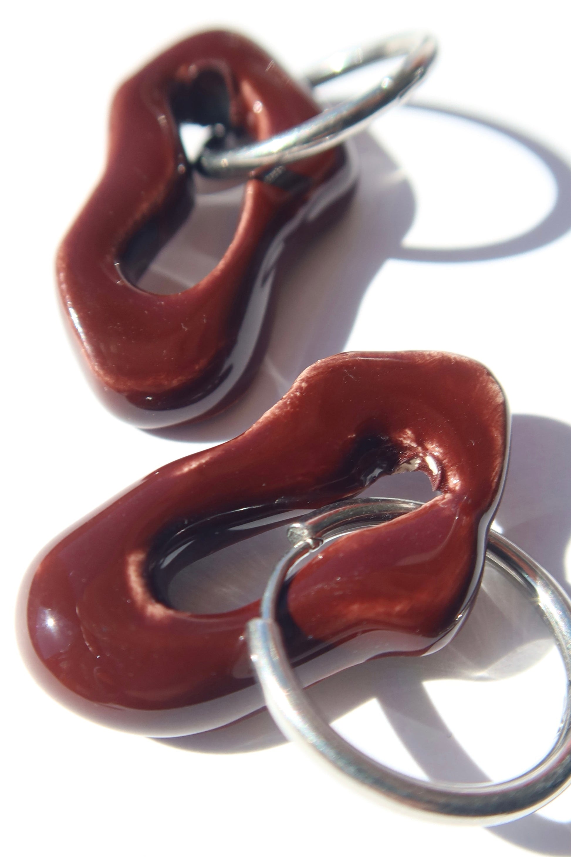 Mosca handmade ceramic earrings in Brown Red — organic sculpted clay with glossy glaze, made in Lisbon Portugal by Jadeo Studio, silver hoop