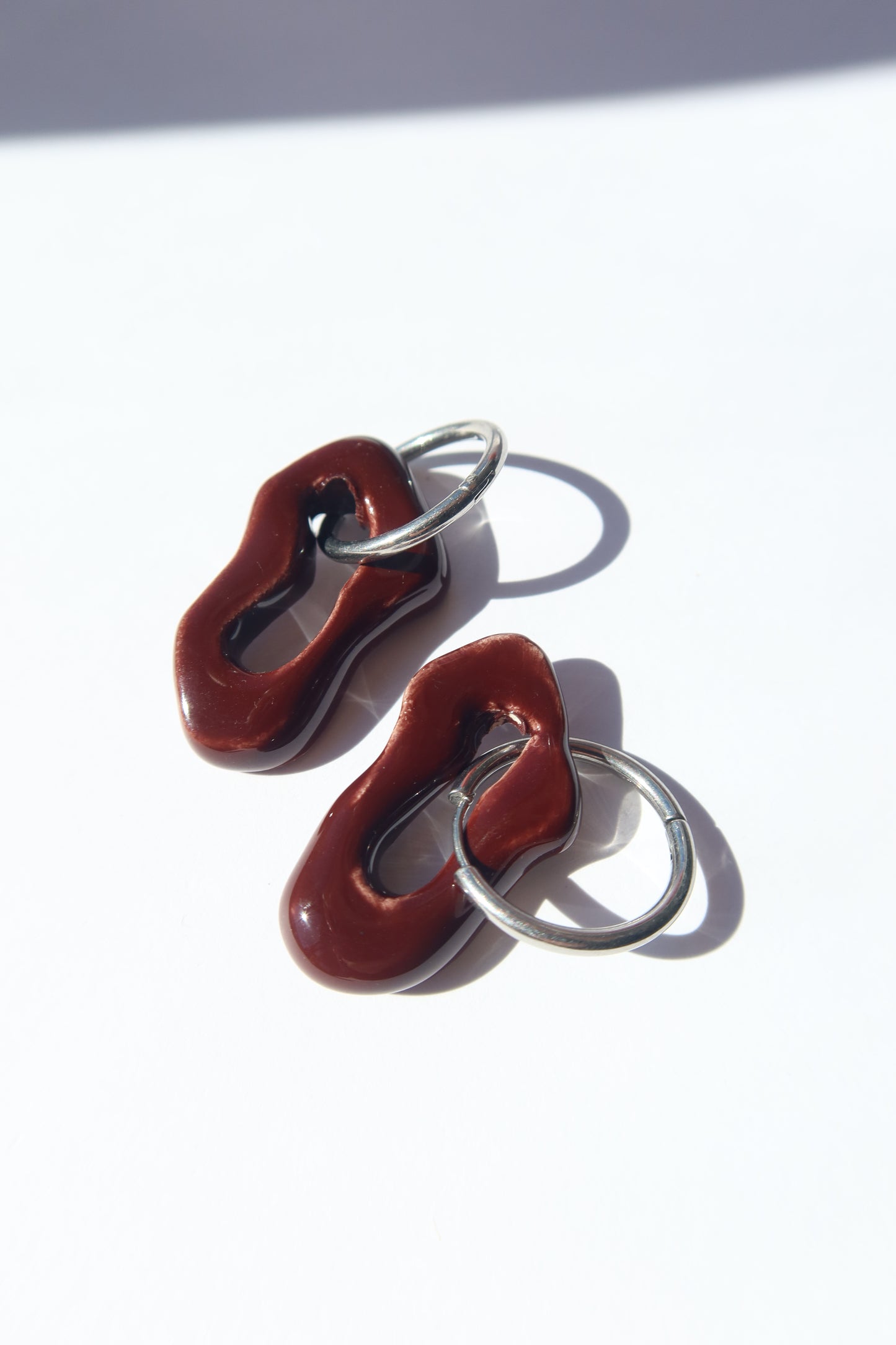 Mosca handmade ceramic earrings in Brown Red — organic sculpted clay with glossy glaze, made in Lisbon Portugal by Jadeo Studio