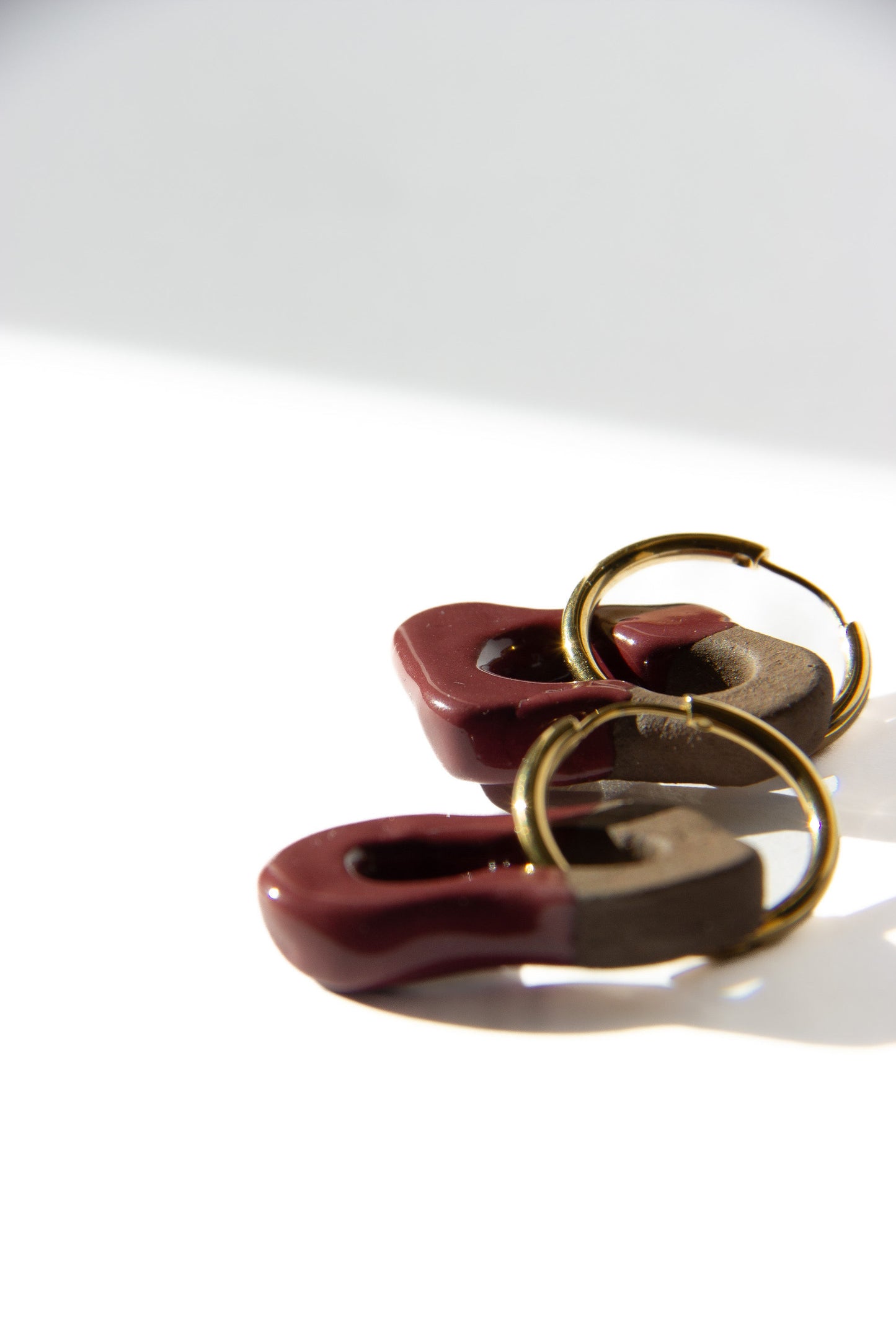 Mosca handmade ceramic earrings in Cherry Dark Clay — organic sculpted clay with glossy glaze, made in Lisbon Portugal by Jadeo Studio, silver and gold hoops