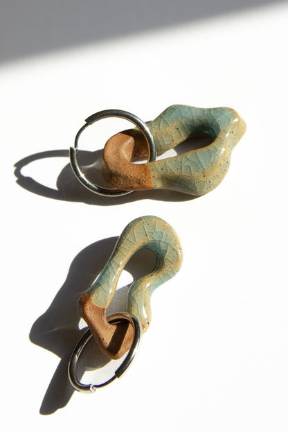 Mosca handmade ceramic earrings in Crackled Light Blue — organic sculpted clay with glossy crackled glaze, made in Lisbon Portugal by Jadeo Studio, silver and gold hoop