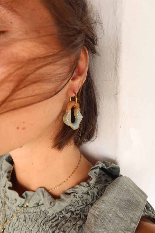 Mosca handmade ceramic earrings in Crackled Light Blue with sunlight — organic sculpted clay with glossy crackled glaze, made in Lisbon Portugal by Jadeo Studio