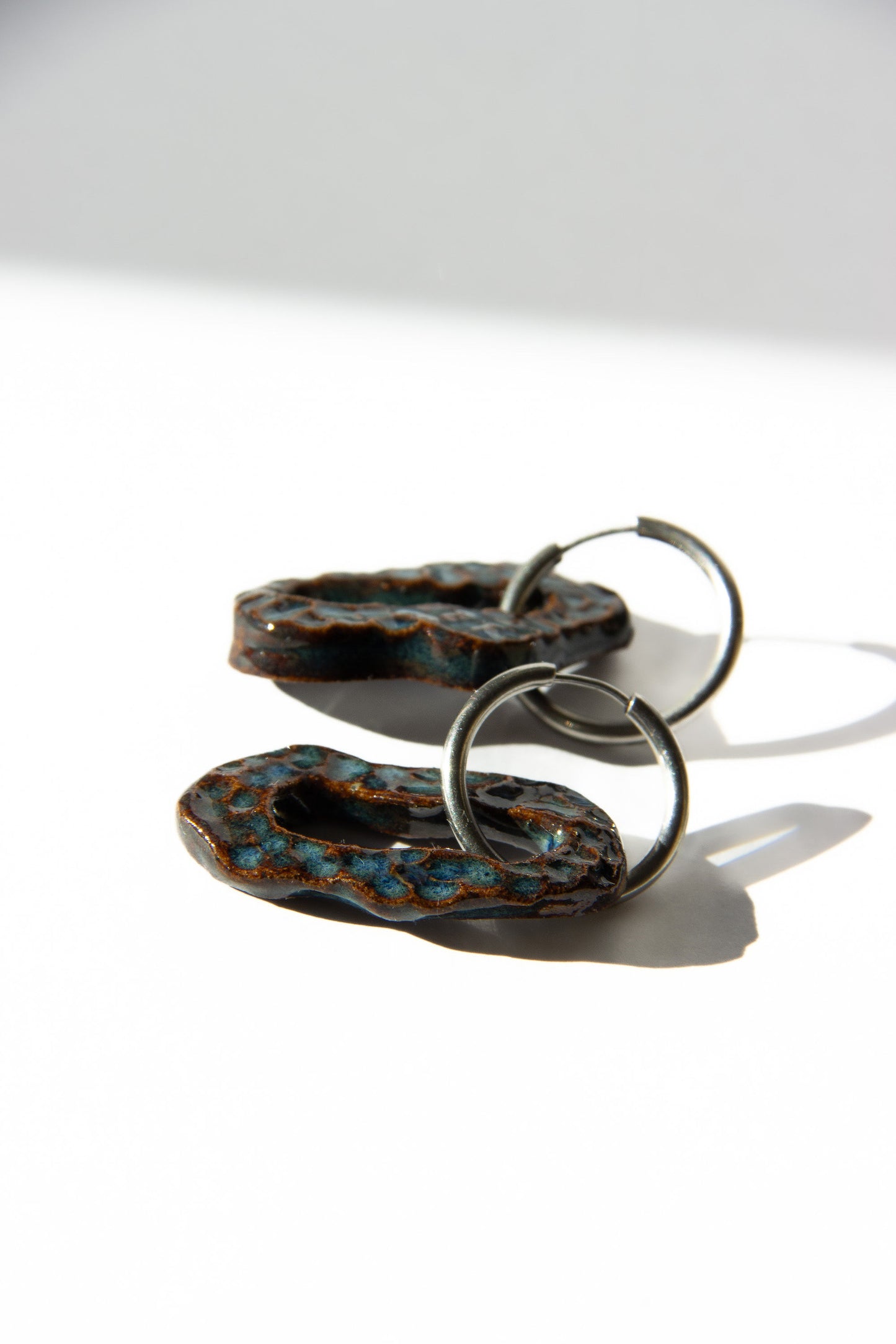 Mosca handmade ceramic earrings in Dotted Blue Jeans — organic sculpted clay with glossy glaze and dotted texture, statement jewlery made in Lisbon Portugal by Jadeo Studio