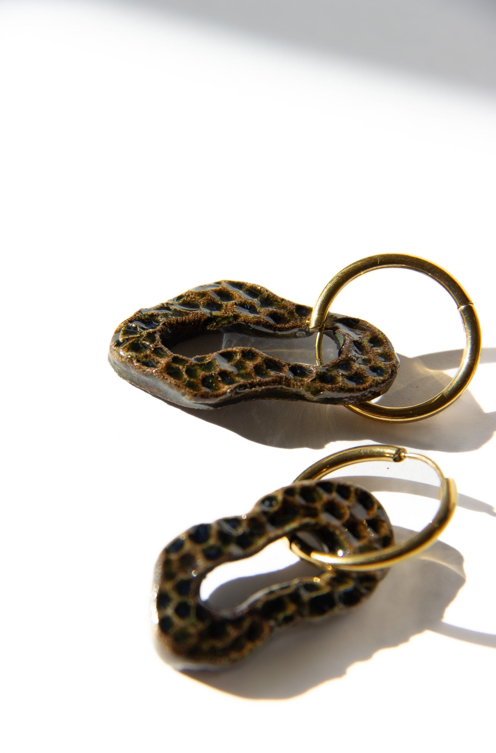 Mosca handmade ceramic earrings in Dotted Dark Green — organic sculpted clay with glossy glaze and dotted texture, made in Lisbon Portugal by Jadeo Studio, silver and gold hoop