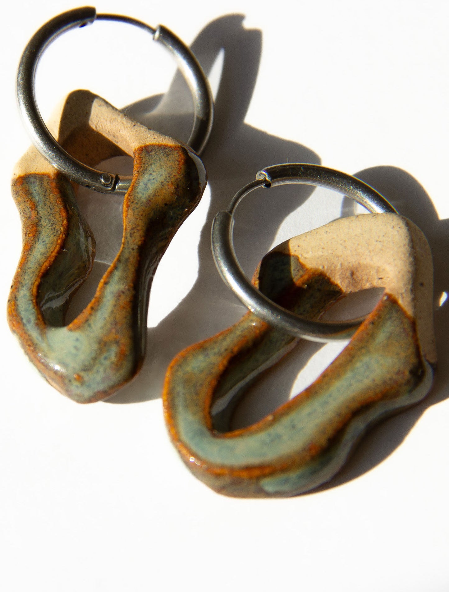 Mosca handmade ceramic earrings in Grey Green — organic sculpted clay with glossy glaze, made in Lisbon Portugal by Jadeo Studio, silver and gold hoop