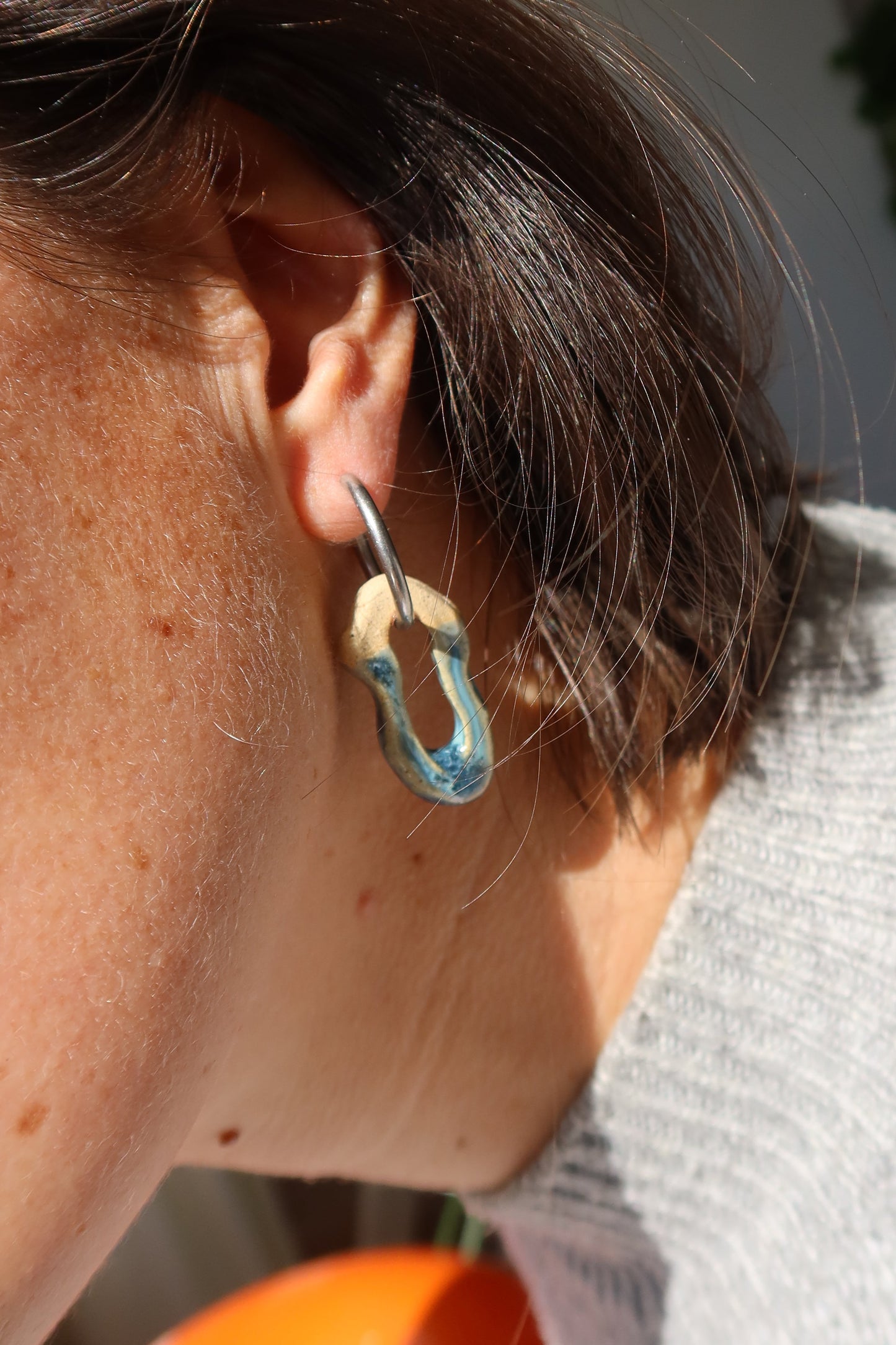 Mosca sparkling blue earrings in natural light — contemporary handmade ceramic jewelry inspired by Lisbon lifestyle, Jadeo Studio