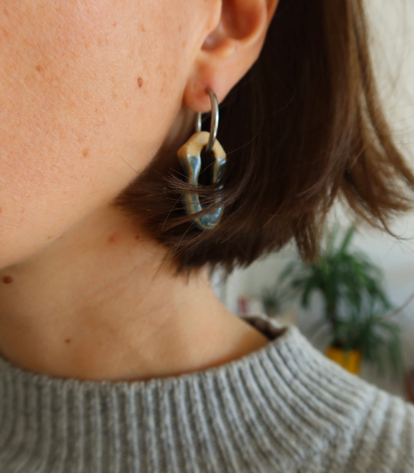 Mosca sparkling blue ceramic earrings worn — lightweight handmade design with glossy glaze, sculpted clay jewelry by Jadeo Studio Lisbon