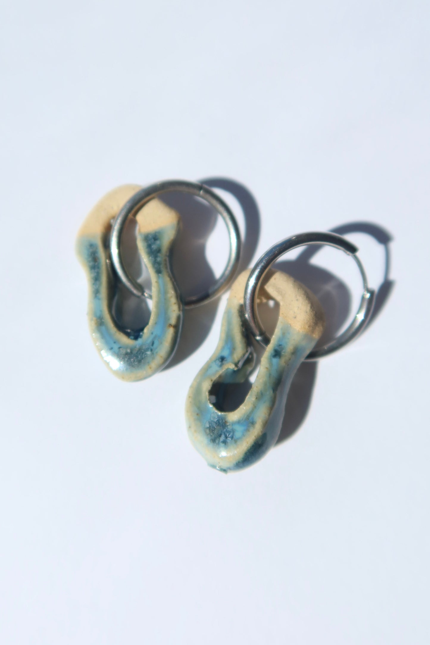 Mosca handmade ceramic earrings in Sparkling Blue — organic sculpted clay with glossy glaze, pair shown in natural light, made in Lisbon Portugal by Jadeo Studio