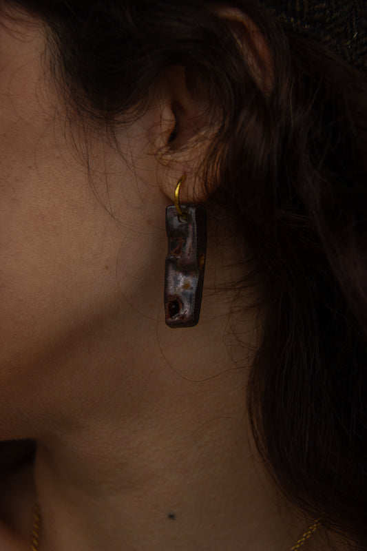Penha handmade ceramic earrings in Bark worn on soft skin — minimalist rectangular drop, sculpted clay, made in Lisbon Portugal by Jadeo Studio