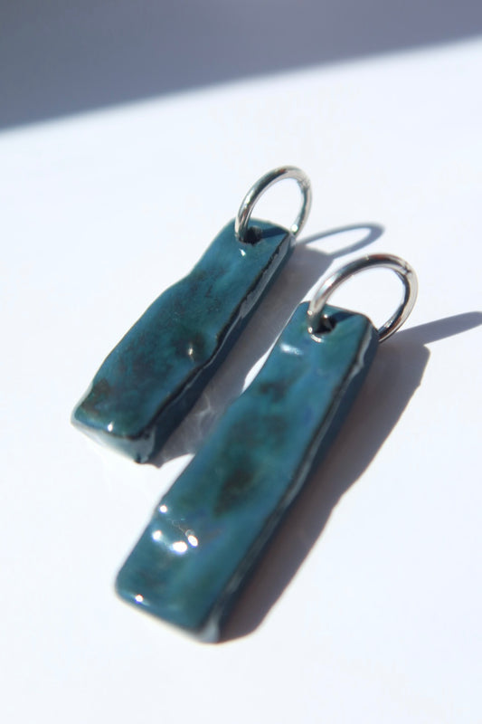 Penha handmade ceramic earrings in Blue Green, glossy glaze — minimalist rectangular drop, sculpted clay, made in Lisbon Portugal by Jadeo Studio