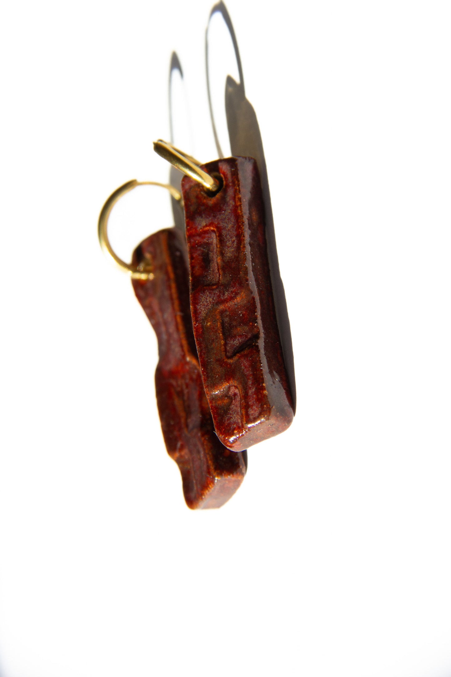 Penha handmade ceramic earrings in Burgundy, glossy glaze — minimalist rectangular drop, sculpted clay, made in Lisbon Portugal by Jadeo Studio