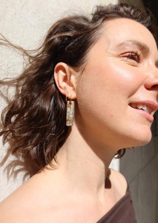 Penha handmade ceramic earrings in Grey Green, sunlight reflectin on statement jewlery — minimalist rectangular drop, sculpted clay, made in Lisbon Portugal by Jadeo Studio