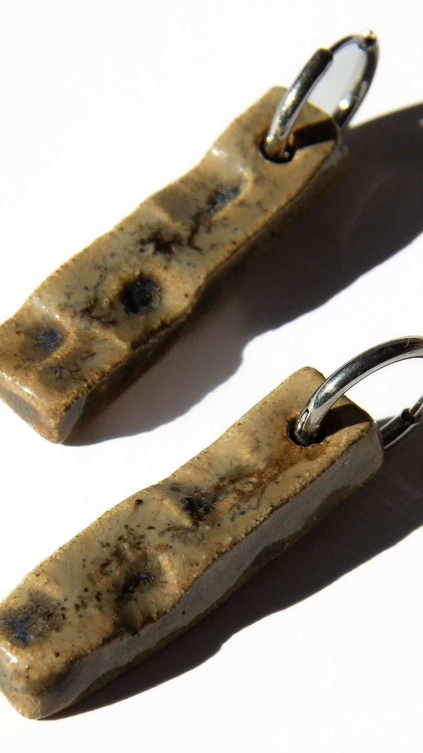 Penha handmade ceramic earrings in Light Beige, glossy glaze — minimalist rectangular drop, sculpted clay, made in Lisbon Portugal by Jadeo Studio