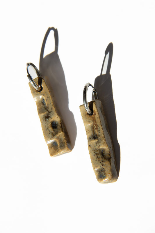 Penha handmade ceramic earrings in Light Beige — minimalist rectangular drop, sculpted clay, made in Lisbon Portugal by Jadeo Studio