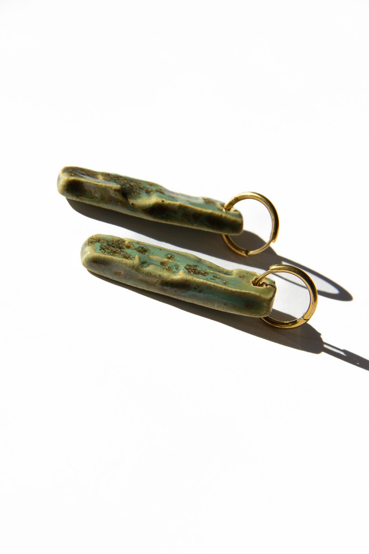 Penha handmade ceramic earrings in Light Green, glossy glaze — minimalist rectangular drop, sculpted clay, made in Lisbon Portugal by Jadeo Studio