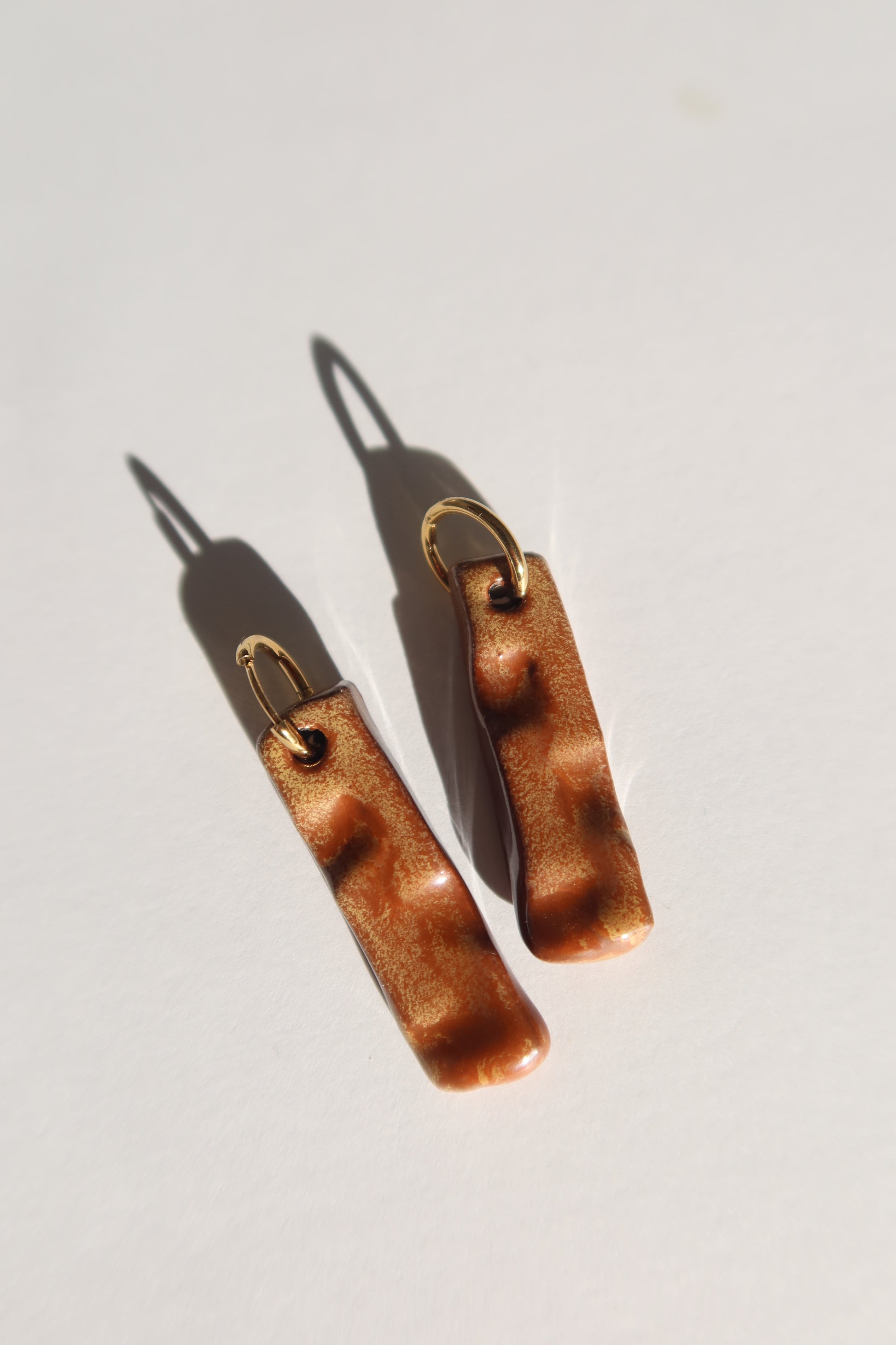 Penha handmade ceramic earrings in Sparkling Brown — minimalist rectangular drop, sculpted clay, made in Lisbon Portugal by Jadeo Studio