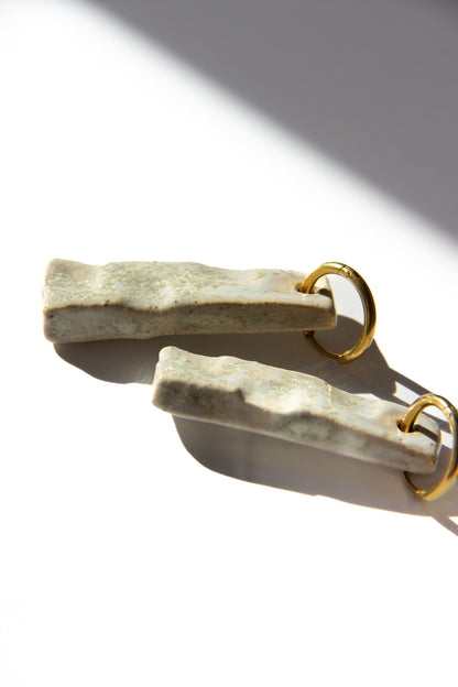 Penha handmade ceramic earrings in Sparkling White, glossy glaze — minimalist rectangular drop, sculpted clay, made in Lisbon Portugal by Jadeo Studio