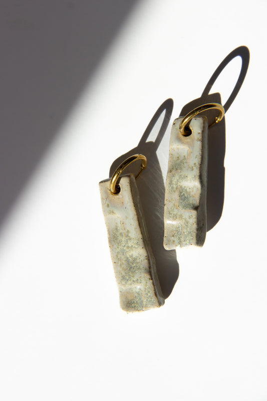 Penha handmade ceramic earrings in Sparkling White — minimalist rectangular drop, sculpted clay, made in Lisbon Portugal by Jadeo Studio