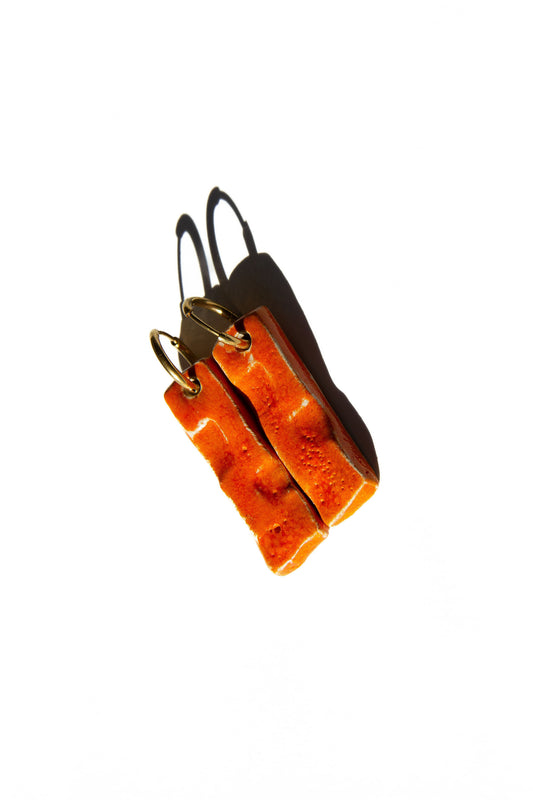 Penha handmade ceramic earrings in Volcano, glossy glaze — minimalist rectangular drop, sculpted clay, made in Lisbon Portugal by Jadeo Studio