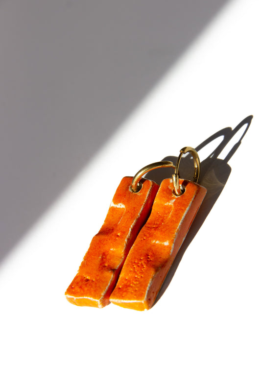 Penha handmade ceramic earrings in Volcano — minimalist rectangular drop, sculpted clay, made in Lisbon Portugal by Jadeo Studio